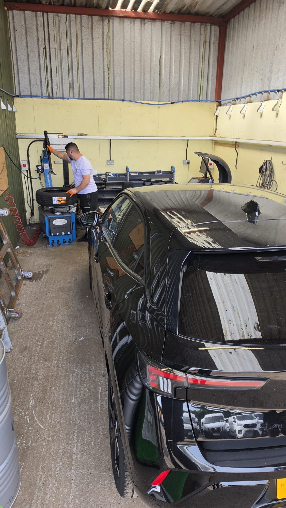NRH Autoworks technician fitting a tyre in the workshop