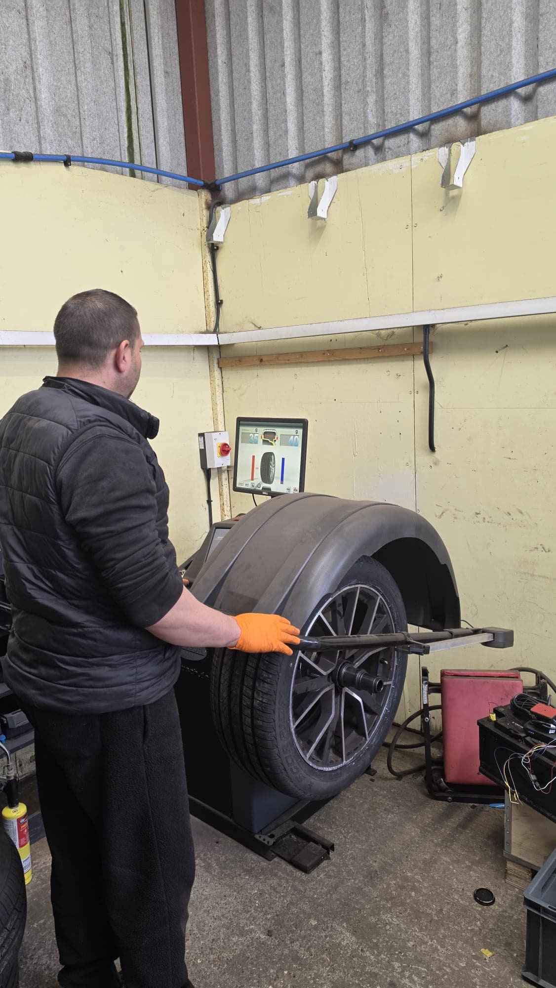 Technician fitting a reversing camera in a van